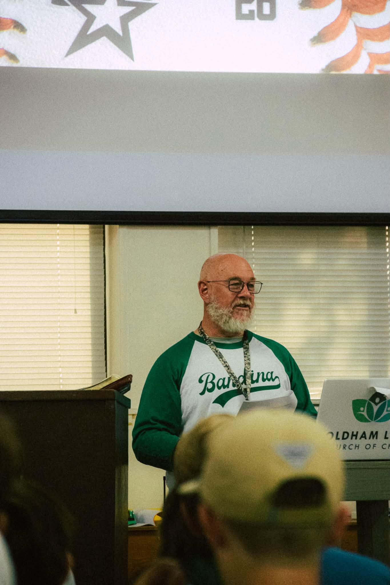 A camp leader teaching from behind the podium